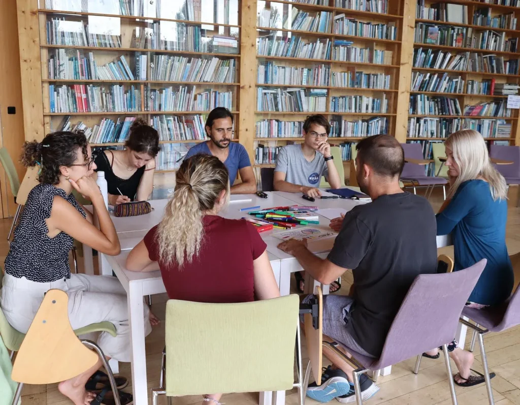 Fabio Meazza facilitating a small-group discussion around a table