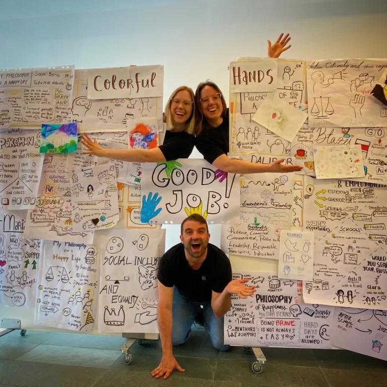 Fabio Meazza with participants and colorful workshop drawings