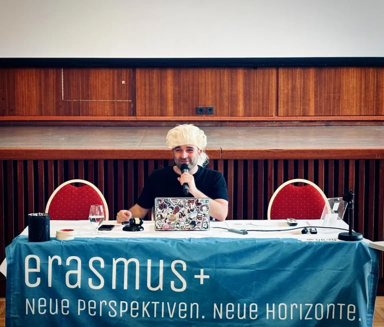 Fabio Meazza speaking into a microphone at an Erasmus+ event