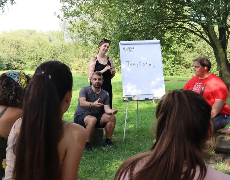 Fabio Meazza facilitating a group discussion in a green outdoor setting