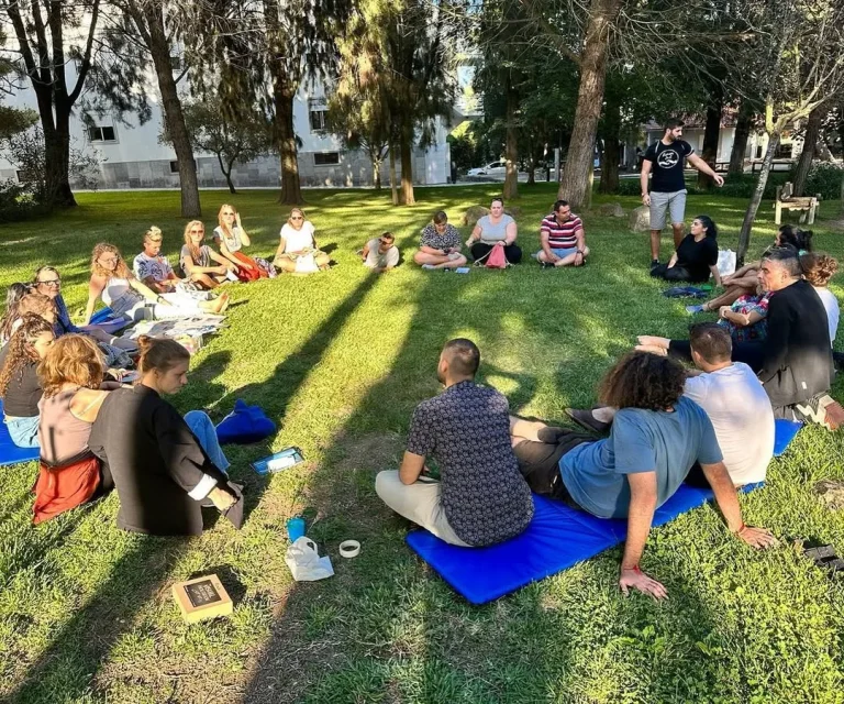 Participants sitting in a circle during an outdoor group session
